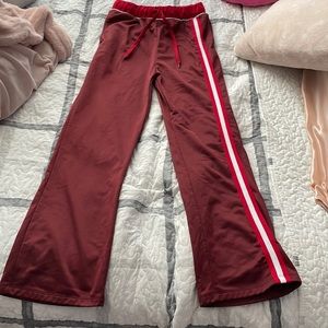 Cute flared red track pants with stripe on the side and coca cola on the back